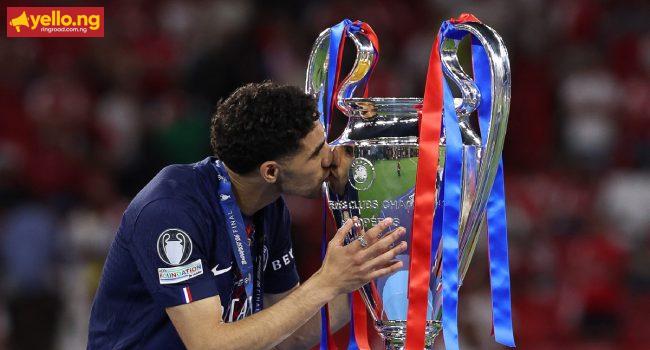 Paris Saint-Germain's Moroccan Defender #02 Achraf Hakimi kisses the trophy after winning UEFA Champions League on May 30, 2026. (Photo by AFP)