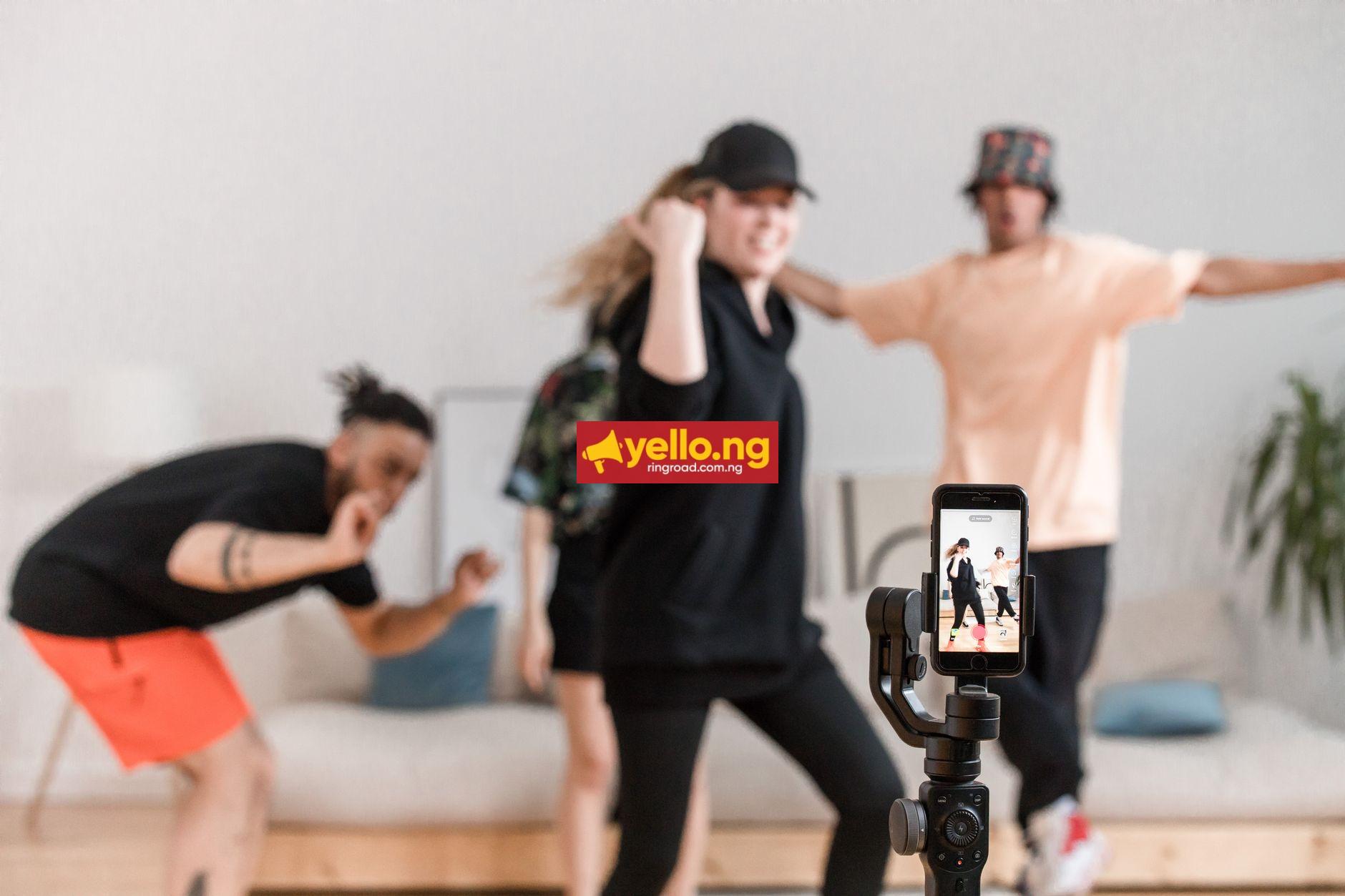 Diverse group of young people dancing and filming a TikTok dance challenge video on a smartphone gimbal