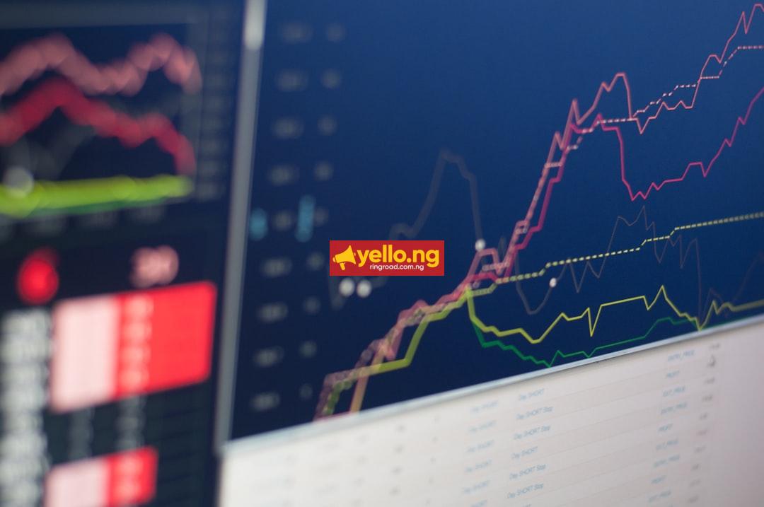 Live stock and currency charts on trading screens showing exchange rate movements