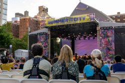 Concertgoers wear haptic suits created for the deaf by Music: Not Impossible, during an outdoor concert at Lincoln Center on July 22, 2023, in New York City. The violins reverberate in the ribcage, while cello and bass are felt a little further down, with horns in the shoulders, and more often than not, soloists in the wrists. That's one way audio expert Patrick Hanlon programs wireless haptic suits designed to enable the deaf or hard of hearing to experience orchestral music, as initiatives to improve inclusivity at live music performances break new ground. At the Lincoln Center concert, audience members tried vests featuring 24 points of vibration that translate the music onstage. (Photo by ANGELA WEISS / AFP) (Photo by ANGELA WEISS/AFP via Getty Images)