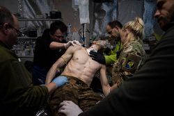 Ukrainian military medics treat their wounded comrade at the field hospital near Bakhmut, Ukraine, on Feb. 26.